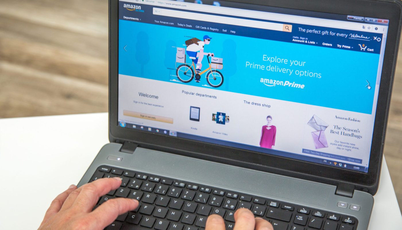 Paris, France - January 27, 2017 : Man using a laptop to connect to the Amazon Prime homepage . Amazon Prime is an annual subscription offered by amazon covering a set of privileges and services, standard free shipping and orders within 1 day